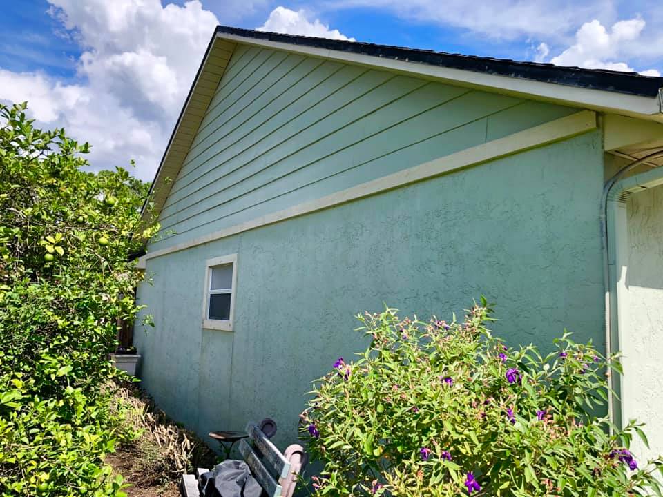 Stucco wall after Avalon Park pressure washing services, with a clean and bright appearance